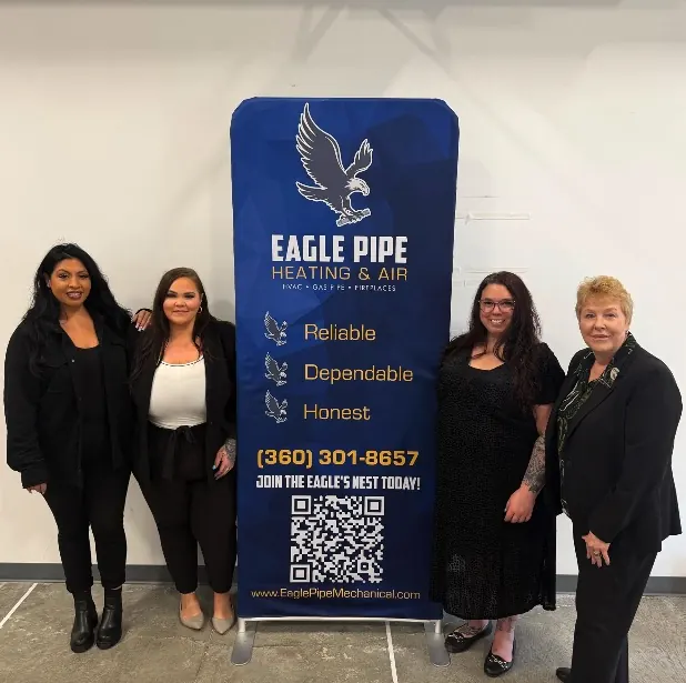 Eagle Pipe office team in front of Reliable, Dependable, Honest banner